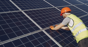 renewable energy worker working on a solar panel
